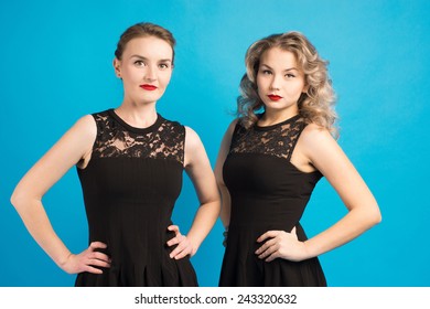 two beautiful girls in the same black dress