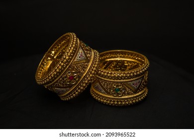 Two Beautiful Gold Bangle Isolated On Black Background. Jewellery Stock Photo.