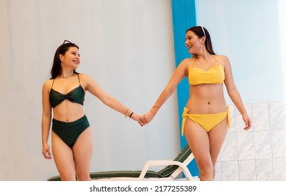 
Two Beautiful Hot Babes In Bikinis Walking Hand In Hand