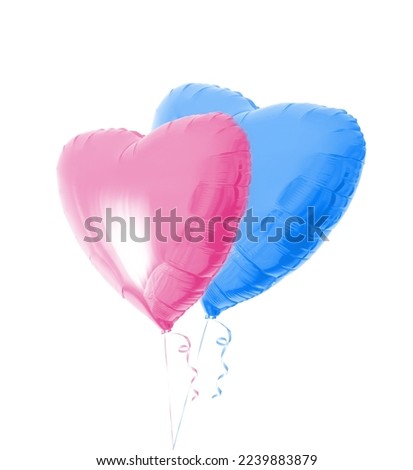 Two beautiful light pink and blue heart shaped balloons with ribbons isolated on a white background. Love symbol. Birthday party decor. Helium gas. Birth waiting of a boy or girl. Valentines day.