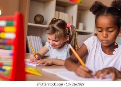 Two Beautiful Little Girls Doing Math At Home As Part Of Homeschooling Due To Covid 19 Pandemic Social Distancing Measures; Children Studying And Doing Homework At Home