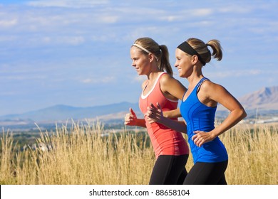 Two Beautiful Middle-aged Female Joggers Training For A Marathon