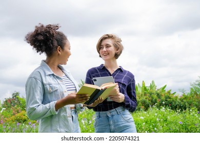 Two Beautiful Multi-ethnic Students In The Park. Further Education. Scholarships. Concept Of Colleges And Universities. Informal Education. Educational Concept. Positive Concept. Summer Vacation.