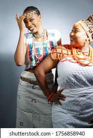 Two beautiful Nigerian woman dressed in cultural attires with a Nigerian Flag