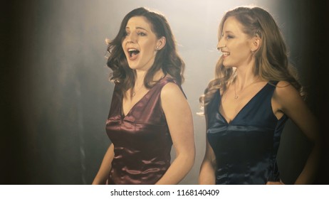 Two Beautiful opera singer girl. 4k Portrait close up of the artist singer.