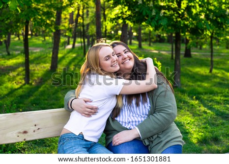 Similar – Happy women embracing and laughing over nature background