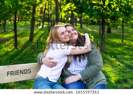 Similar – Happy women embracing and laughing over nature background