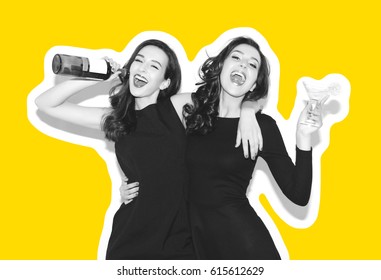 Two beautiful women in black night fashion dress posing isolated on a white gray background. Pretty brunette girl friends twins having fun drinking cocktails. Singing and dancing. Bottle of wine.