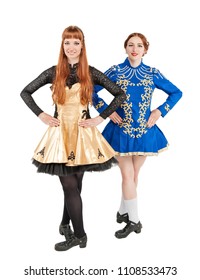 Two Beautiful women in dresses for Irish dance isolated on white