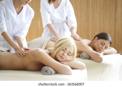 Two Beautiful Women Getting Massage In Spa