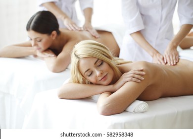 Two Beautiful Women Getting Massage In Spa