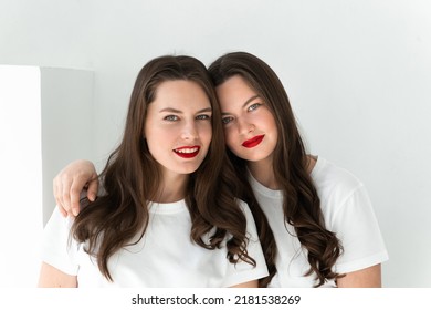 Two beautiful women twin sisters posing white background - Shutterstock ID 2181538269