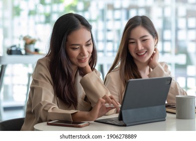 Two beautiful young asian businesswoman working together using digital tablet at office. - Shutterstock ID 1906278889