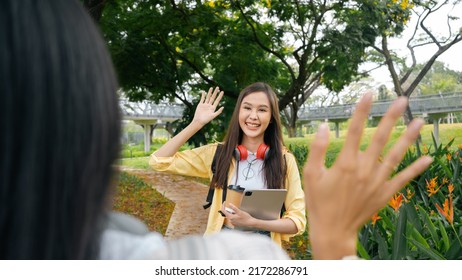 Two Beautiful Young Asian Students Are Hugging Each Other Lovingly In The Park. Further Education, Scholarship, Opportunity.University Graduate ,say Hi Hello ,good Bye,happy Students Positive Concept.