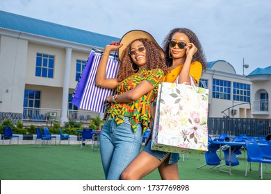 Two Beautiful Young Black Women Posing Shopping Bags