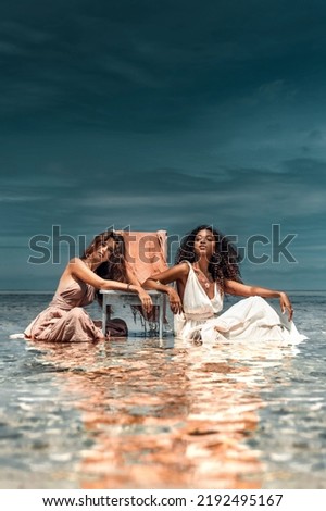 two beautiful young girls outdoors with chair