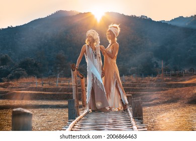 two beautiful young stylish women wearing turban outdoors at sunset