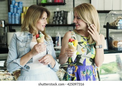 Two Beautiful Young Woman Eating An Italian Ice Cream, Selective Focus