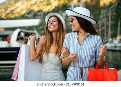 Two beautiful young women enjoying shopping and travel in the city.