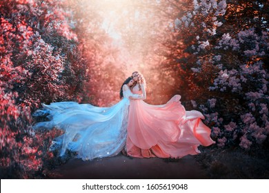 two beautiful young women long dress hug embrace train fly wind. bright fabulous fantasy autumn artwork retouching processing. Natural cosmetics spring flowers love smell perfume. Blonde brunette hair - Powered by Shutterstock
