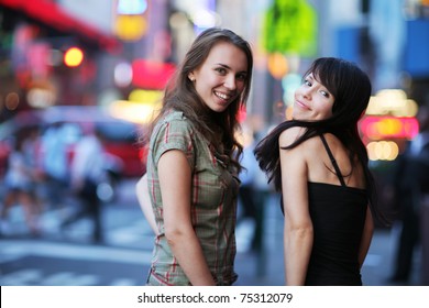 Two Beautiful Young Women At Times Square In New York City. Shallow DOF.