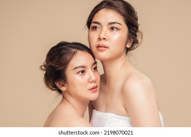 Two beautyAsian woman with healthy skin glowing hydrated and natural makeup on beige background. Beautiful female skin care concept. - Shutterstock ID 2198070021
