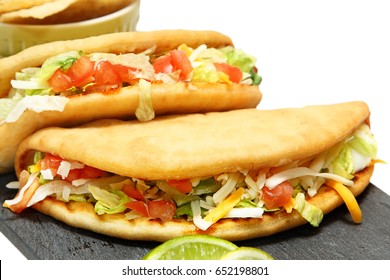 Two Beef Chalupas with lime and chips.