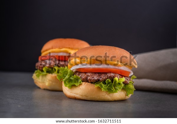 Two beef sliders\
consist of beef burger and cheddar cheese, mixed sauce, tomatoe\
rings, onion lettuce.