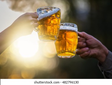 Two Beer Mugs Clink