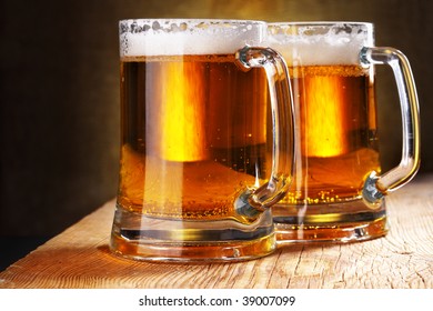 Two Beer Mugs Close-up On Wooden Table