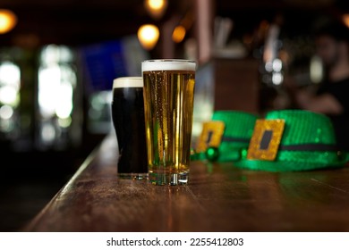 Two beers, hats and costume for St. Patrick's Day at the bar of an Irish pub - Powered by Shutterstock