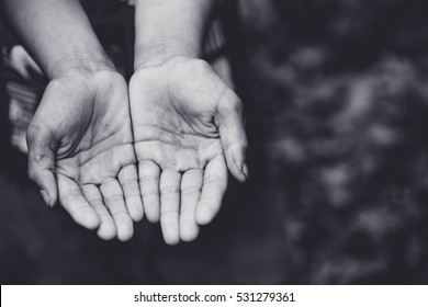 Two beggar hands palms up.Poor children Concept.Black and white.