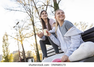 Two Best Female Friends Sitting At The Skate Park And Joying In Coffee To Go.