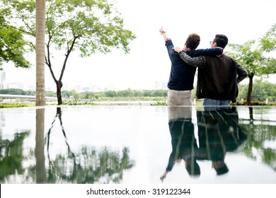 Two Best Friends Hugging And Looking At The Distance, View From The Back