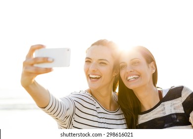 Two Best Friends Taking A Selfie With Cellphone