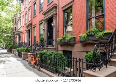 Two bicycles in front of a brownstone building in neighborhood of Brooklyn Heights, New York