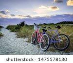 Two bicycles in the sand at sunset at Fort Myers beach in Florida