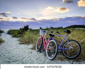 Two bicycles in the sand at sunset at Fort Myers beach in Florida