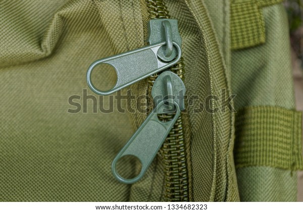two big green\
metal zip on the backpack\
matter
