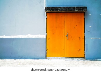 Two Big Old Barn Door With Concrete Wall Background Texture. Old Big Orange Color Gate With Concrete Wall Texture Surface