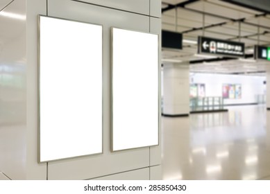 Two big vertical / portrait orientation blank billboard on modern white wall with subway concourse background - Shutterstock ID 285850430