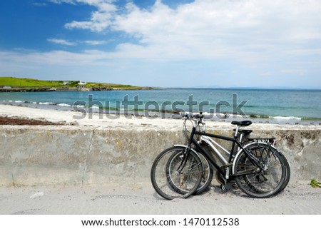 Two bikes near sandy beach on Inishmore, the largest of the Aran Islands in Galway Bay, Ireland. Famous for its strong Irish culture, loyalty to the Irish language, and a wealth of ancient sites.