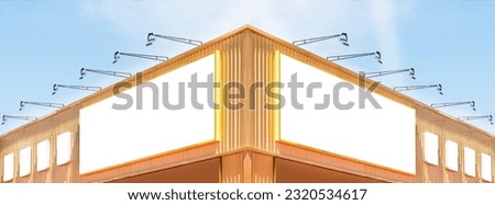Two billboard white background  on yellow and red building with spot light