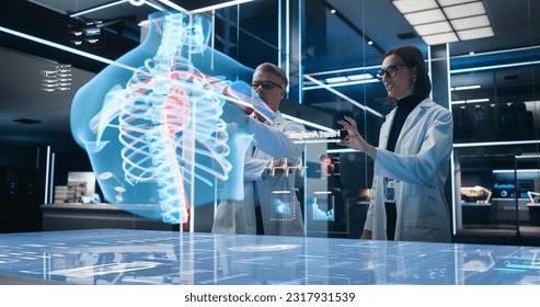 Two Bioengineers Working With Computer-Powered VFX Hologram Of Human Chest With Heart And Blood Flow In Futuristic Lab. Caucasian Man And Woman Working On Innovative Heart Attack Prevention. - Powered by Shutterstock - Get 15% off with code: PIKWIZARD15