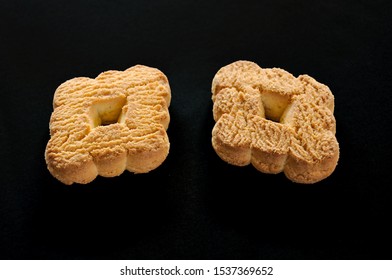 Two Biscuits Isolated In Black Background