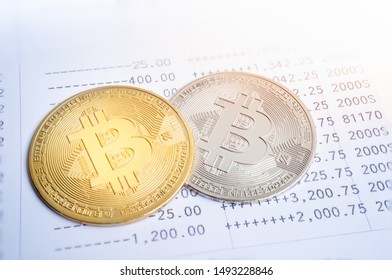 Two Bitcoin On Book Bank. Digital Cyber Safety Or Security Encryption. Manage Bitcoin Price Schedule Concept. Money Laundering Bitcoin Concept. Market Manipulation.