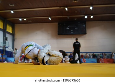 Two BJJ Brazilian Jiujitsu Fighters At The Tournament Fighting Jiu Jitsu Leg Lock Attack