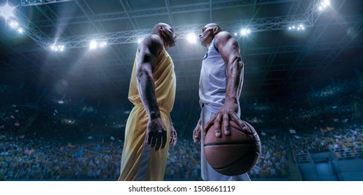 Two Black Basketball Players On Big Professional Arena Before The Game. Two Teams. Players Collided Face To Face. Player Holds A Ball.