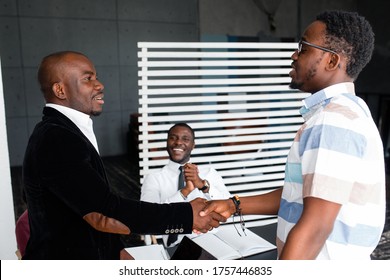 Two Black Businessmen Shake Hands In Honor Of A Deal And Contract Between Firms During Negotiations.