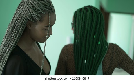 Two black female friends with box braids hairstyle. Young latina women with braided hair